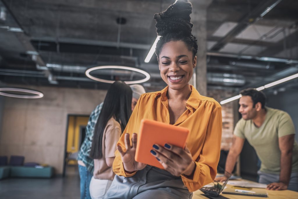 Smiling african american girl with tablet